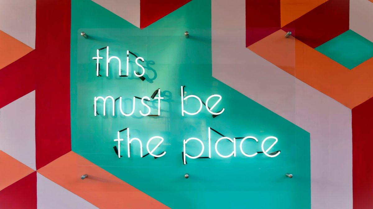 Coloured pattern with the text "this must be the place" in neon writing
