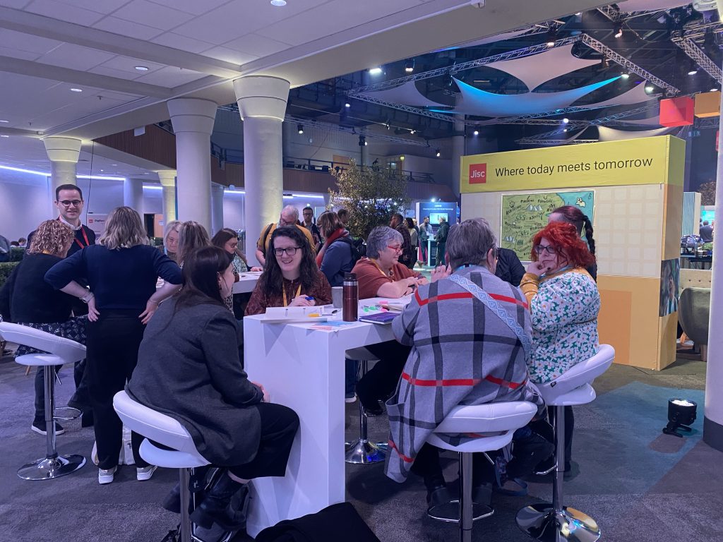 Group of people sitting around a table in deep discussion.