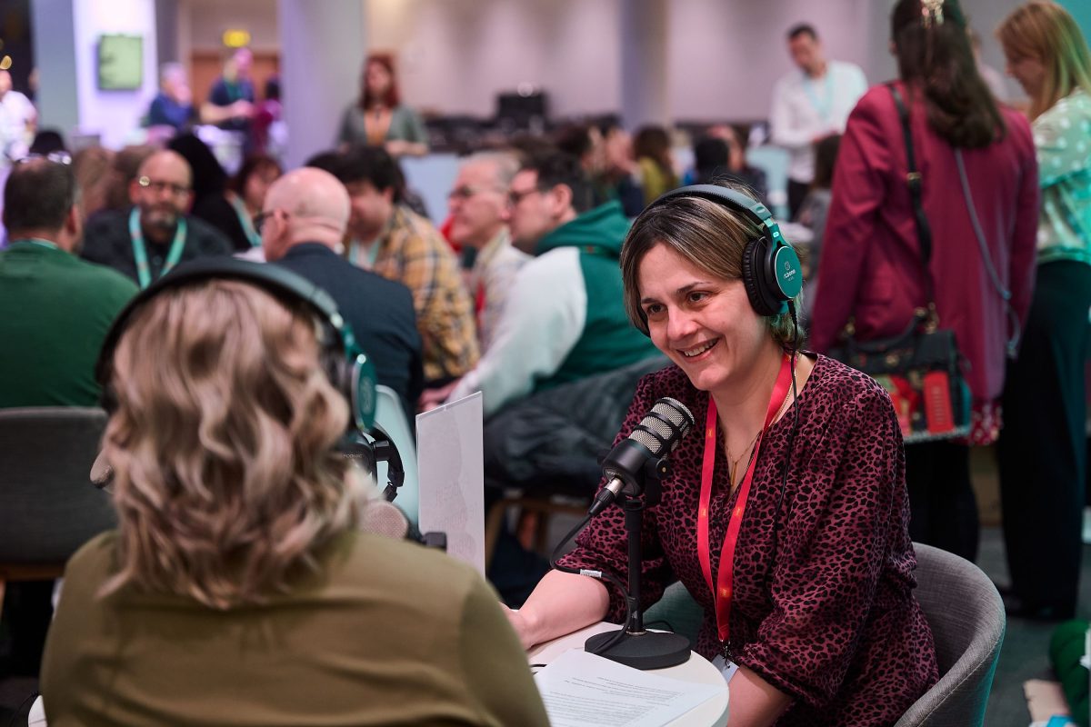 Two people recording a podcast on the Digifest Community Hub. Both are wearing headsets and speaking into microphones